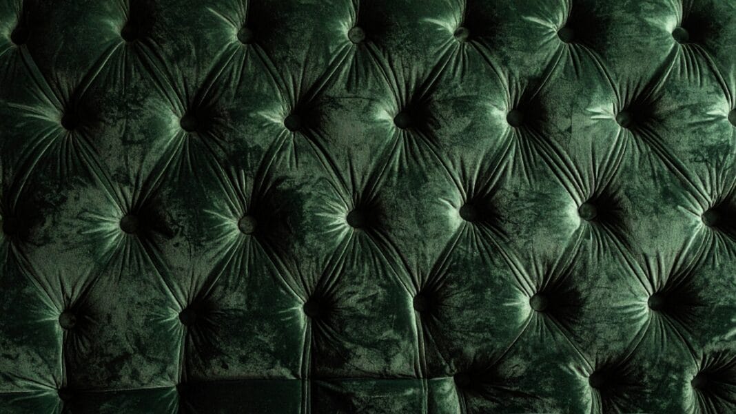 Green velvet upholstery fabric showcasing luxurious tufted texture