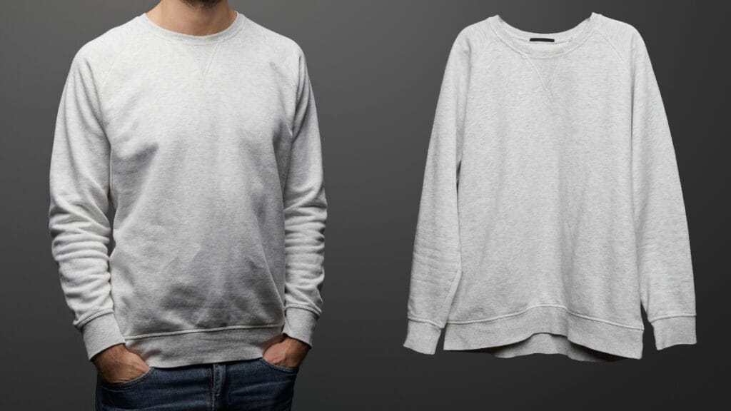 Person wearing a grey sweatshirt, highlighting its comfortable fit and fabric composition