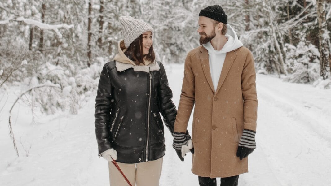 Couple in winter coats or jackets walking in the snow