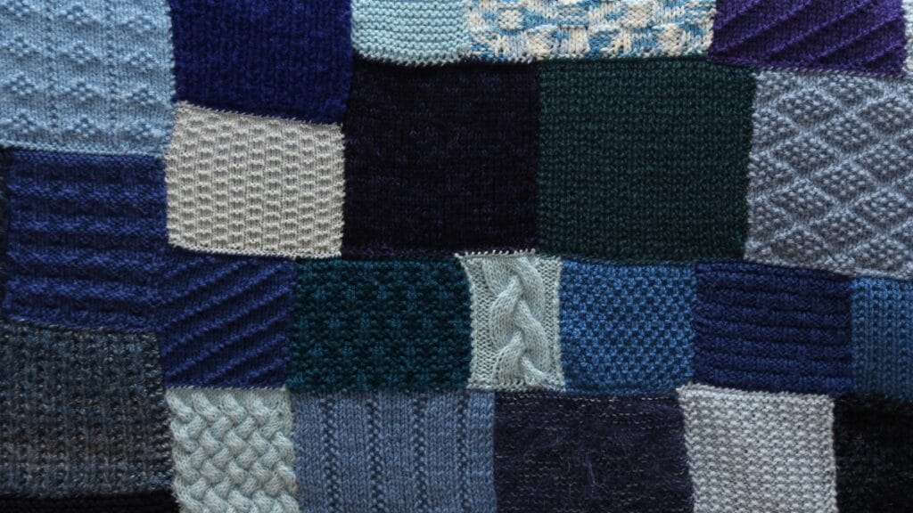 Colorful patchwork pattern made with different knit fabric squares.