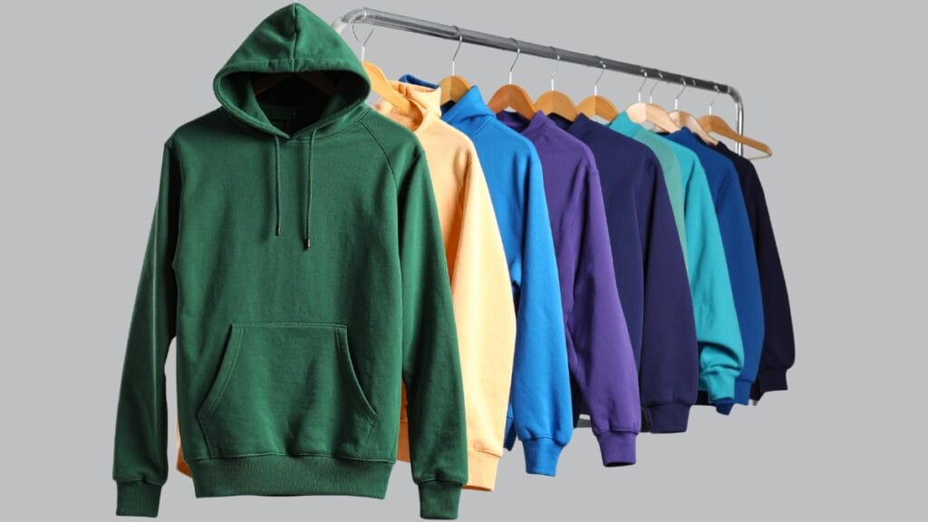 A variety of hoodies in different colors hanging on a rack, featuring casual wear options