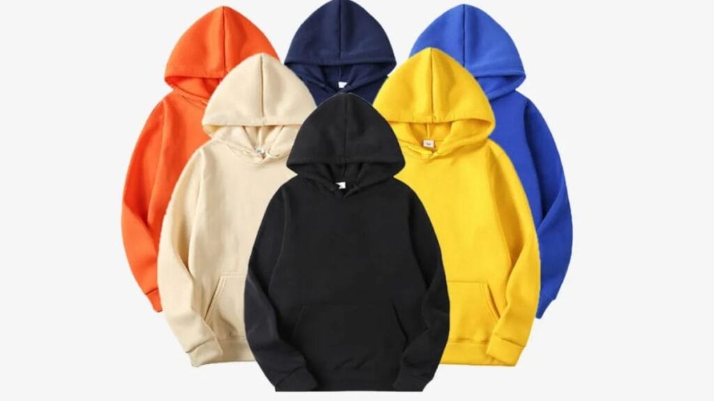 Collection of colorful hoodies in black, beige, orange, yellow, and blue displayed against a plain background