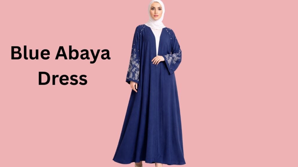 Woman wearing a dark blue abaya dress with silver embroidery sleeves and a white hijab.