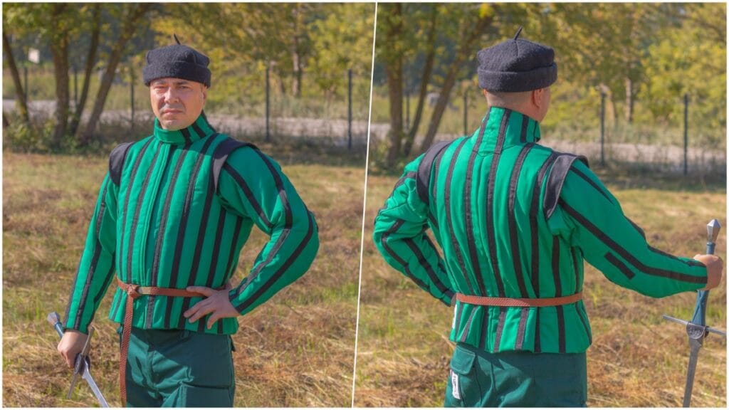 A man in a green-and-black striped medieval-style outfit (doublet with matching cap) holding a sword, shown from the front and then from behind/side against an outdoor park background with trees and grass