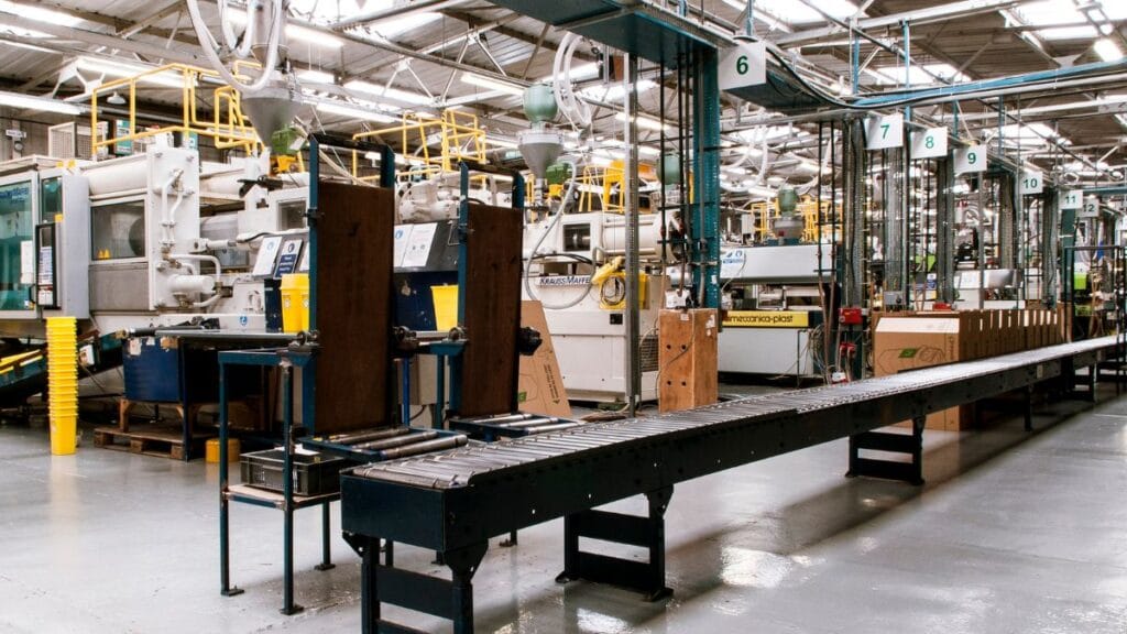 Industrial manufacturing facility with conveyor belt system, machinery, and automated equipment used for large-scale production.