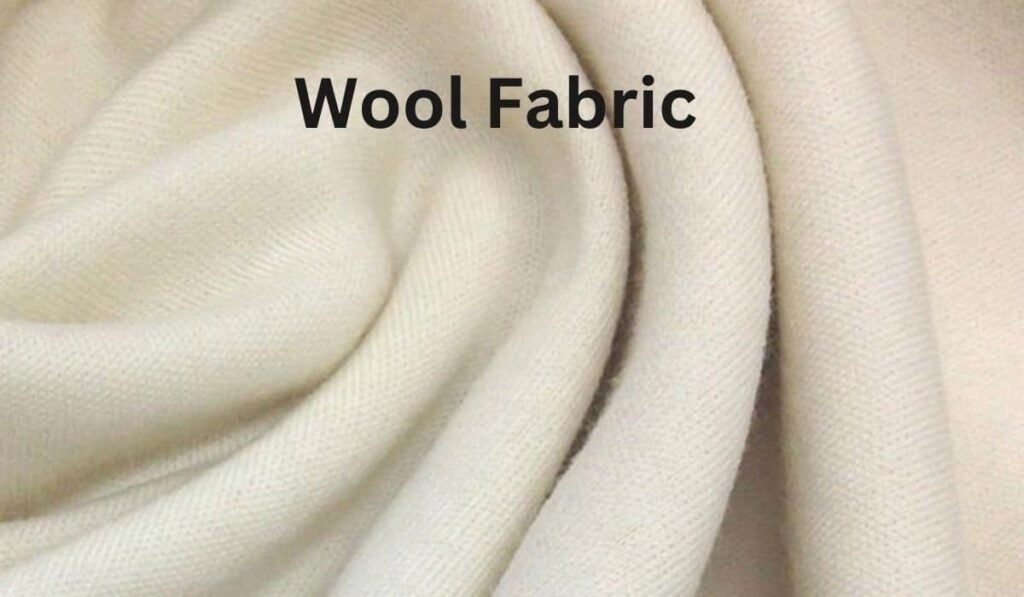 Close-up of soft cream wool fabric, highlighting its smooth texture and weaving patterns."