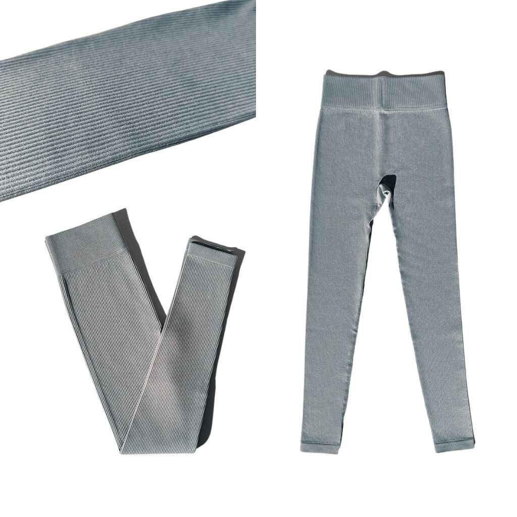 A pair of stylish ribbed joggers in a warm beige tone, showcasing a fitted design with an elastic waistband and cuffs, arranged on a simple, textured surface.