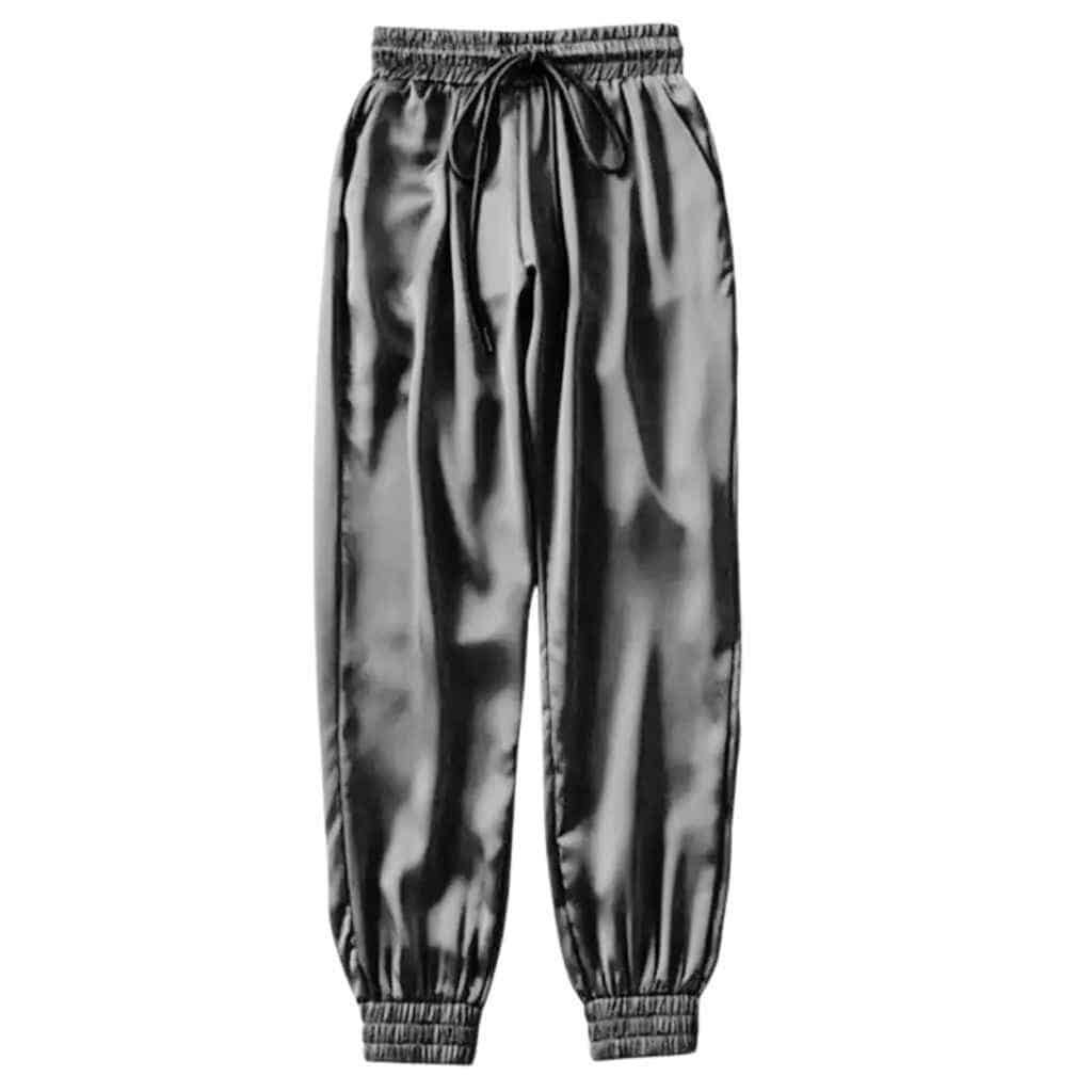 A pair of sleek black satin joggers with a relaxed fit, featuring an elastic waistband and cuffs, displayed on a minimalist background.