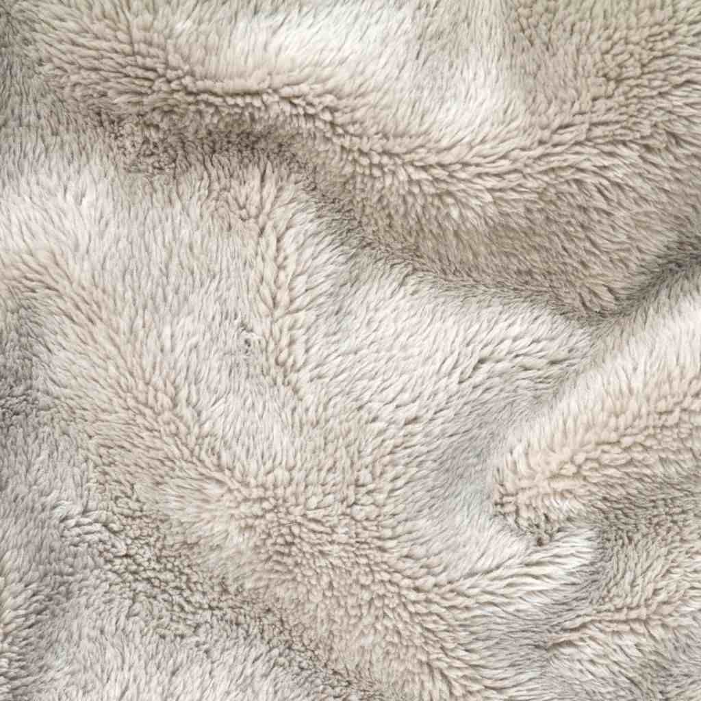 Soft fleece fabric draped on a surface, showcasing its texture and versatility.