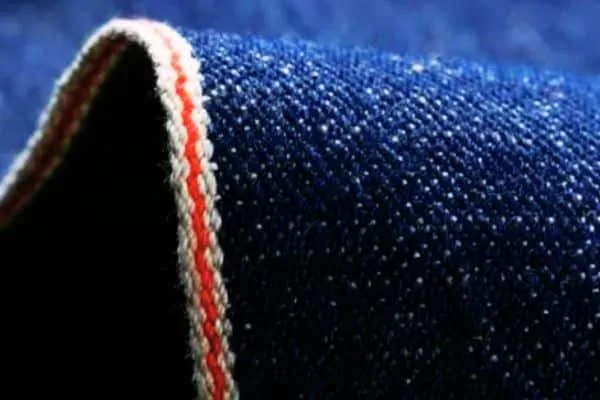 Blue raw denim fabric swatch.