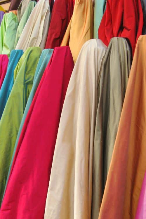 Diverse fabrication choices offered by a leading fashion wear supplier in Greece, including organic cotton and polyester blends.