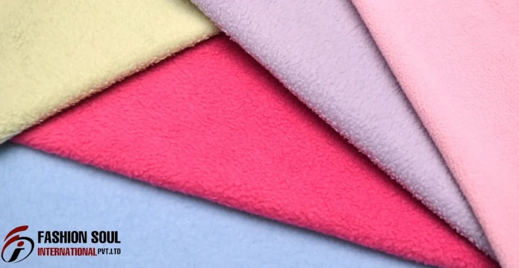 A collection of soft fabric swatches in pastel colors arranged in a fan shape. The colors include yellow, pink, purple, and light blue.