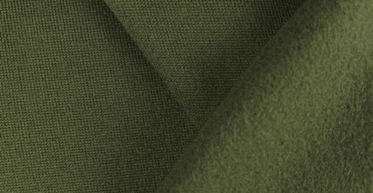Close-up view of green fleece fabric showing its texture and weave.