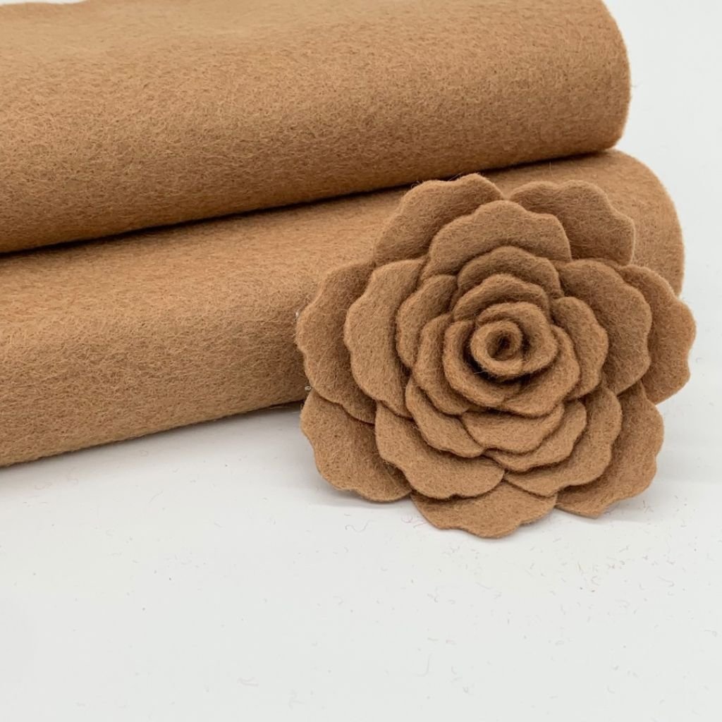 Brown blended felt fabric with a handcrafted felt flower, highlighting its soft texture and versatility.