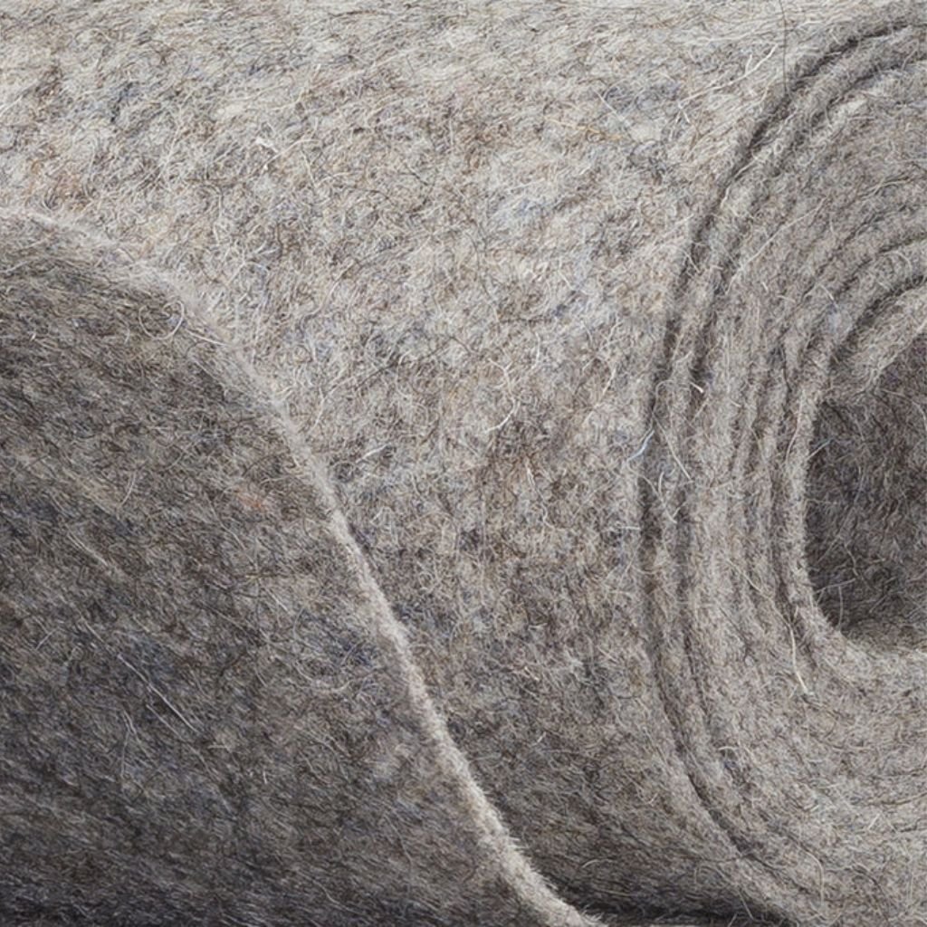 High-quality industrial felt roll in a natural gray tone, offering durability, resilience, and versatility for various applications.