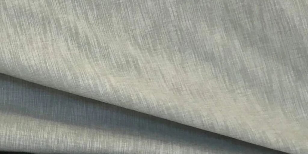 A close-up of luxurious Shantung fabric with a silky texture and elegant sheen, perfect for high-fashion garments and accessories.