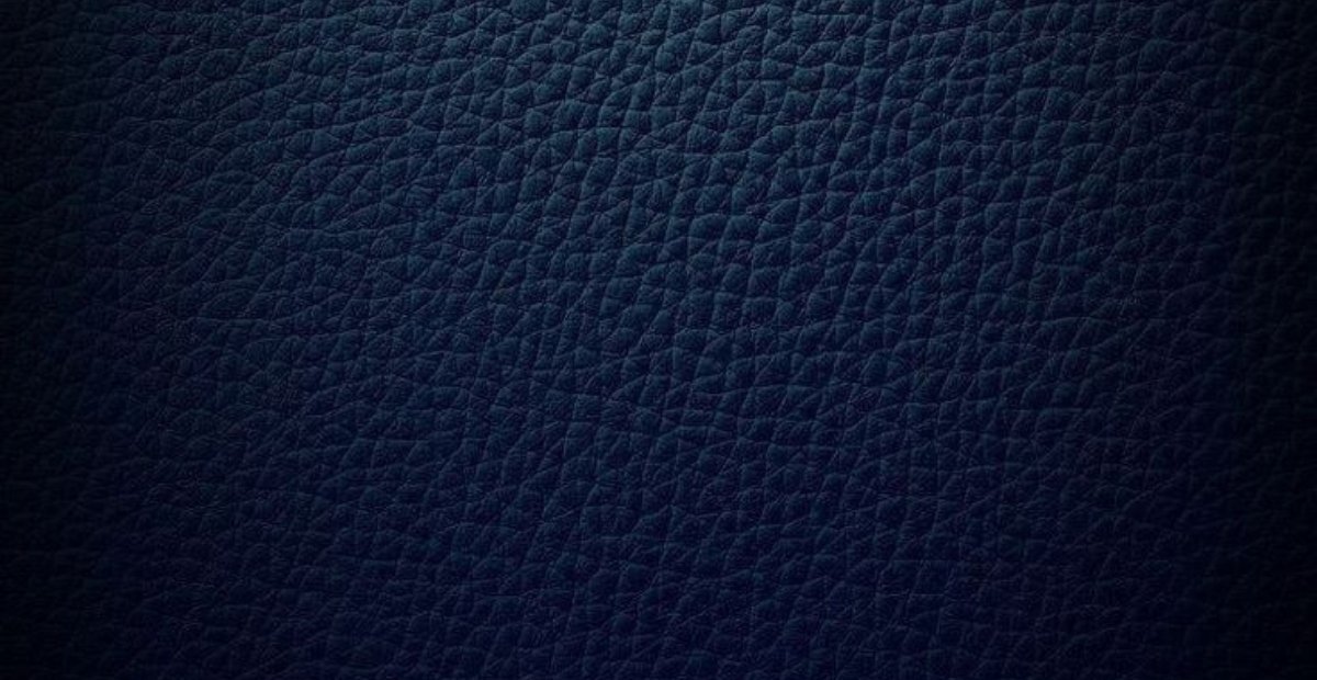 Close-up view of dark blue split leather texture, displaying a fine, crinkled pattern.