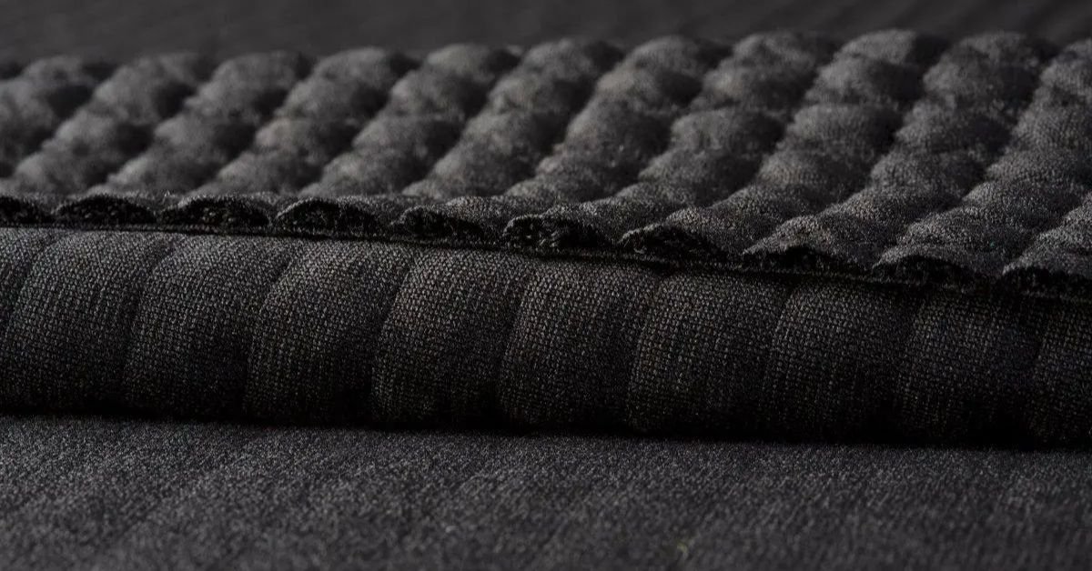 Close-up view of Polartec fabric showing its quilted texture, soft insulation, and high-performance warmth.