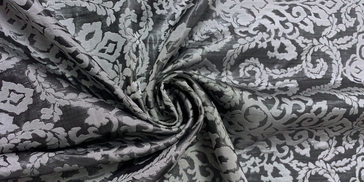 A close-up of luxurious damask fabric showcasing its intricate woven patterns and elegant sheen.