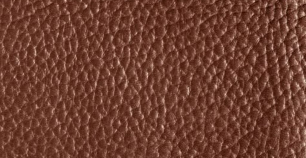 Close-up of textured brown PU leather.