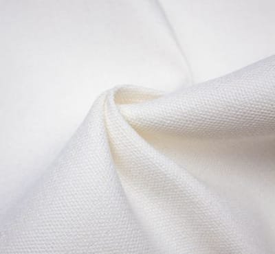 Close-up of white canvas fabric showing texture and fold.