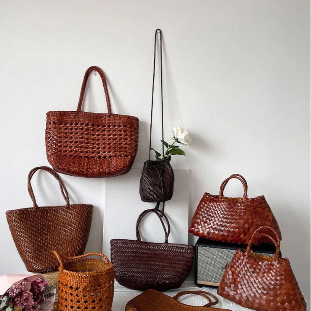 Various pieces of cowhide leather in different colors and textures hanging in a display.