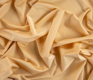 Wrinkled beige lycra fabric.