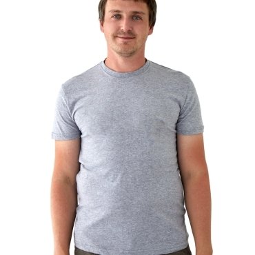 A man smiling while wearing a gray t-shirt, standing against a plain white background.