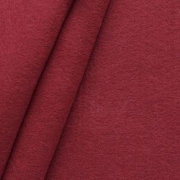 A close-up image of folded maroon baize fabric, showcasing its soft texture.