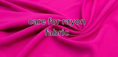Close-up of vibrant pink rayon fabric with smooth folds.