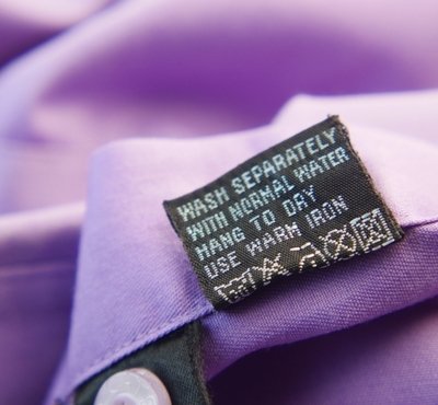 Care label on a purple chiffon shirt.