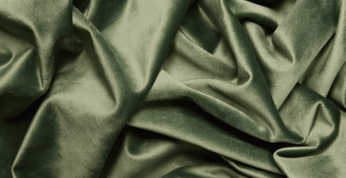 Close-up of wrinkled green rayon fabric. " how to launder rayon fabric"