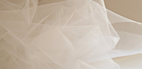 Close-up of soft, sheer white tulle fabric, delicately layered.