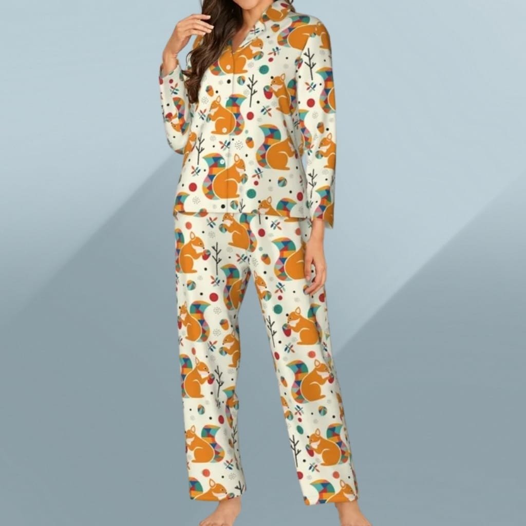 A woman wearing colorful, whimsical pajamas with a playful animal and geometric pattern, standing against a light blue background.