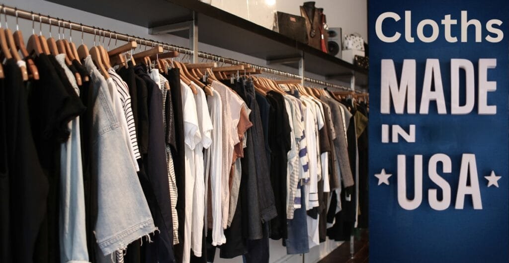 A display of various clothing items hanging on a rack inside a store, next to a large blue sign that reads "Cloths MADE IN USA."