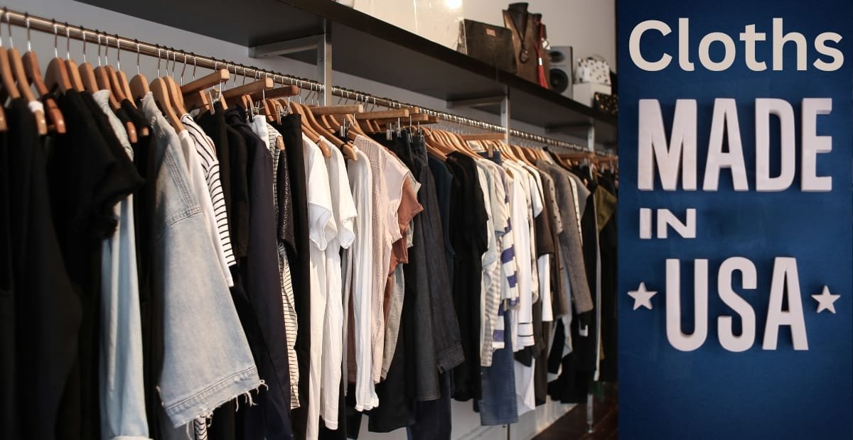 A display of various clothing items hanging on a rack inside a store, next to a large blue sign that reads "Cloths MADE IN USA."