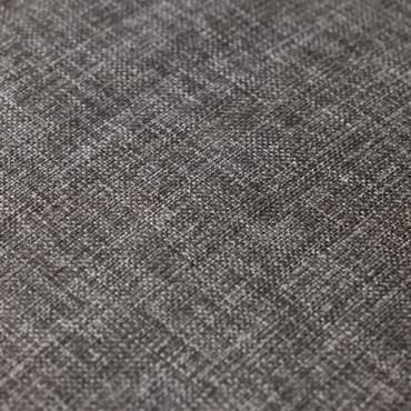 Close-up image of cotton chambray fabric, showing a tight, woven texture with a mix of light and dark gray threads.