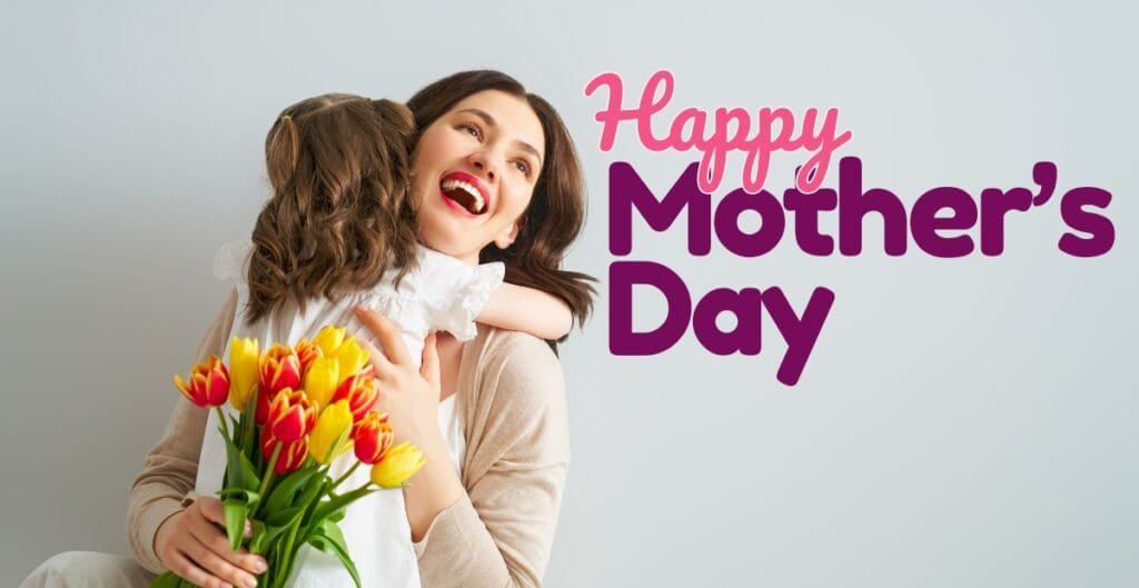 A woman smiling joyfully while hugging a young girl holding a bouquet of yellow and red tulips, with the text "Happy Mother’s Day" in pink and purple displayed on the right.
