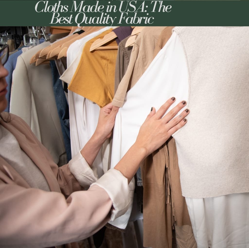 A person examining a rack of various clothing items made from fabrics in neutral tones, with their hand touching a white garment, highlighting the quality and variety of fabrics.