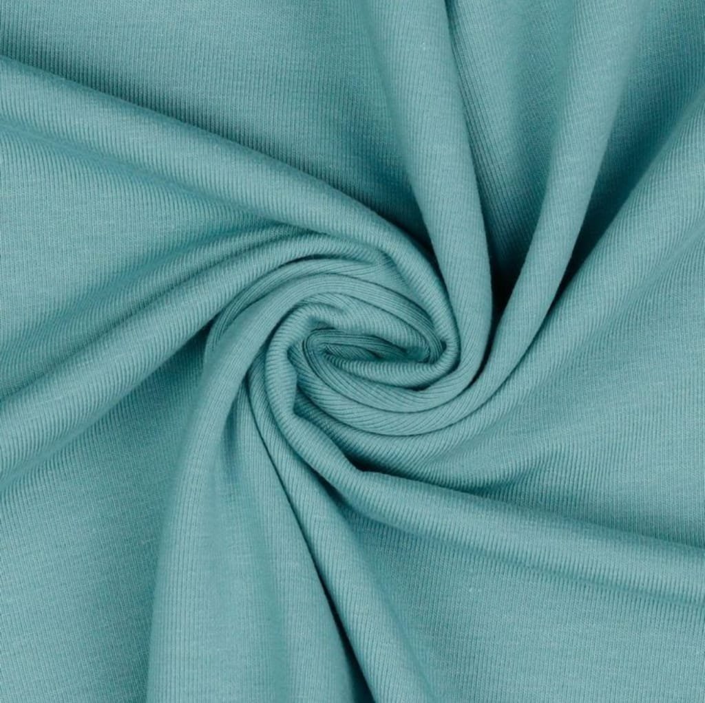 Close-up image of a smooth, light turquoise Jersey cotton fabric with gentle folds and a soft texture.