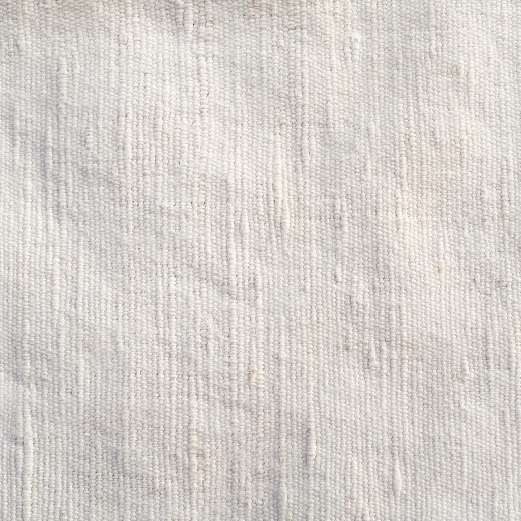  Close-up image of a light-colored, textured fabric surface with a subtle woven pattern.