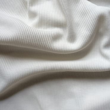 Close-up of soft, ribbed white polyester fabric, showing a comfortable, cozy texture.