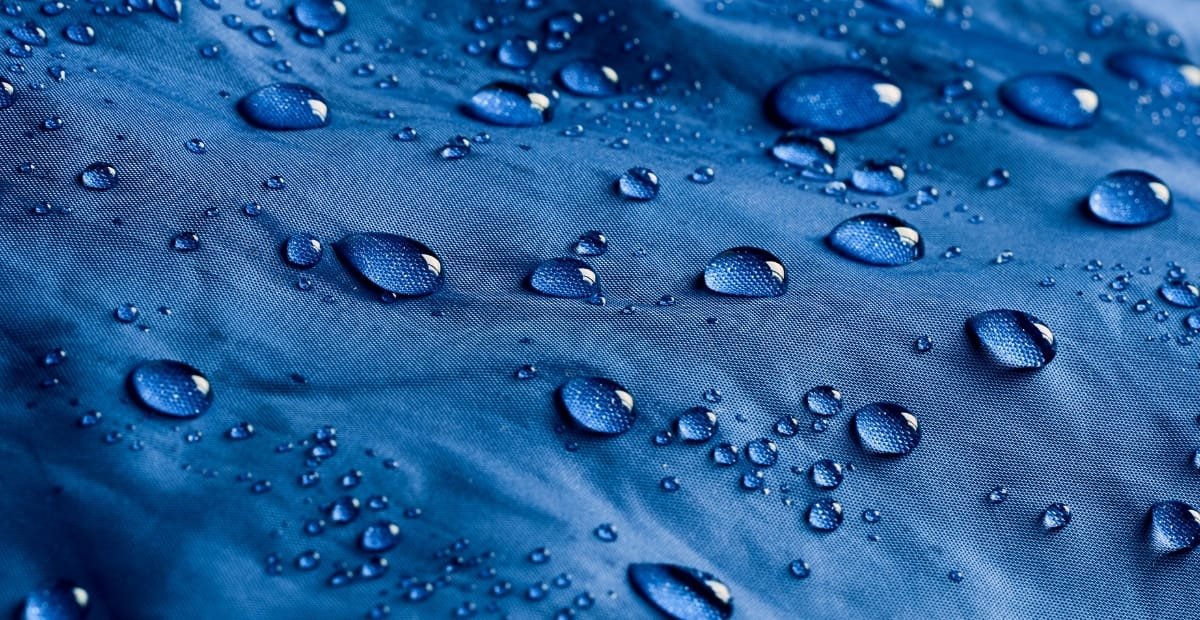 A close-up image of polyester microfiber fabric that is waterproof, showing a smooth, tightly woven surface.