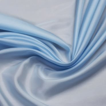 Light blue, silky fabric with a smooth, flowing texture, gently draped in soft folds, suitable for summer clothing.