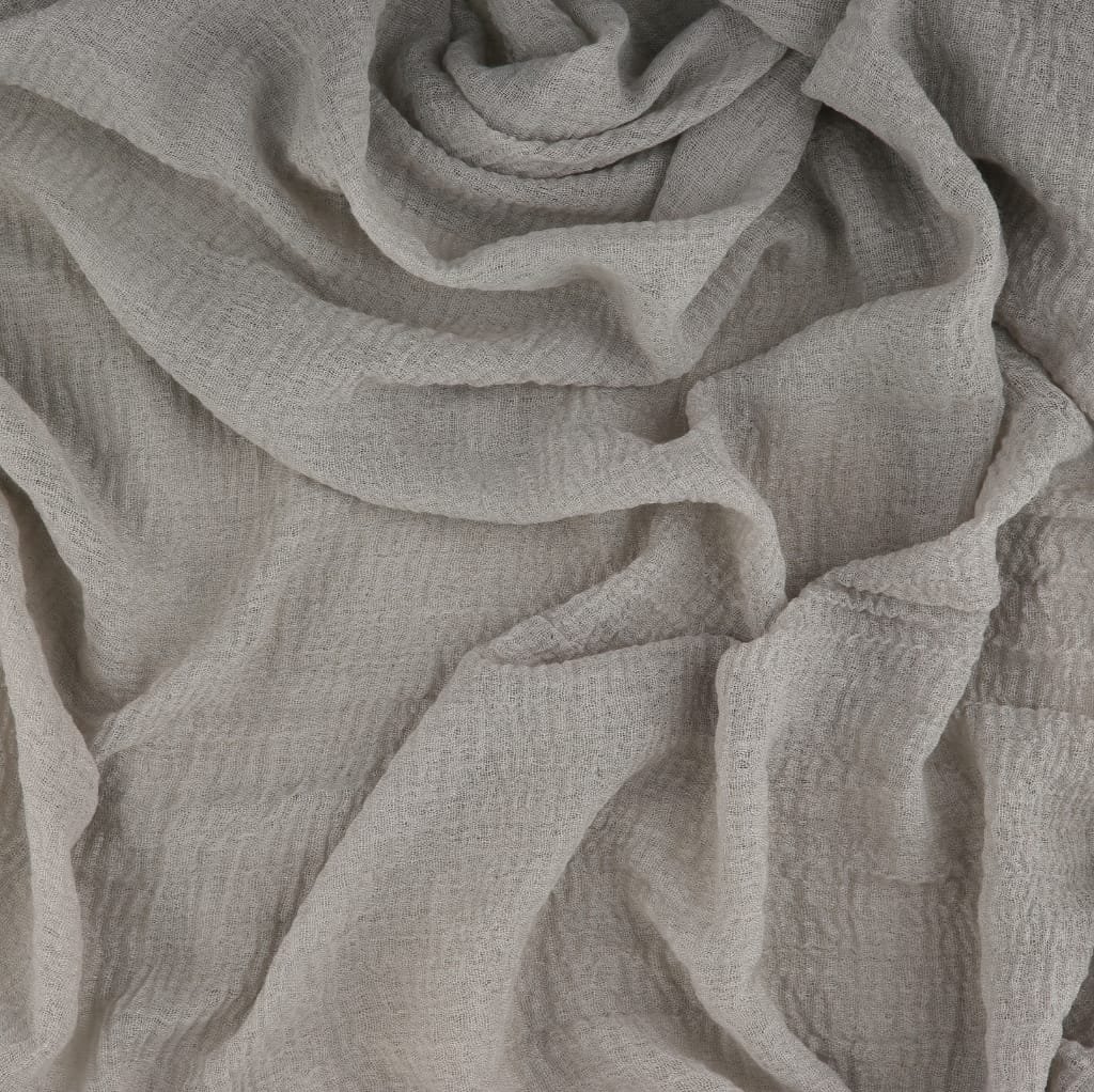 Close-up image of light gray, soft, textured cotton gauze fabric with gentle folds and a slightly crinkled appearance.