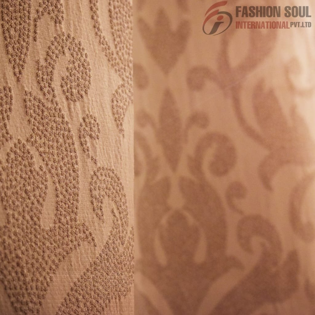 Close-up view of a beige fabric with intricate, textured floral and leafy embroidery patterns, with the logo "FASHION SOUL INTERNATIONAL PVT. LTD" in the top right corner.