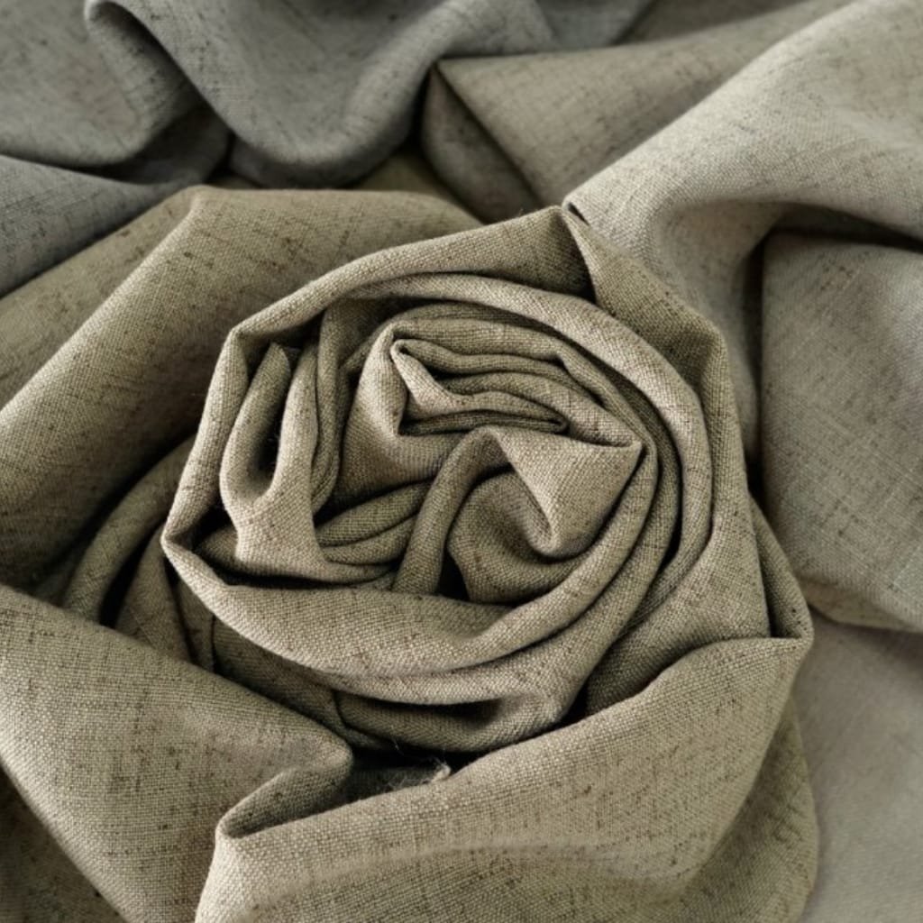 A close-up photograph of beige linen fabric arranged in a way that it forms spiral and folds, creating a textured and layered appearance.