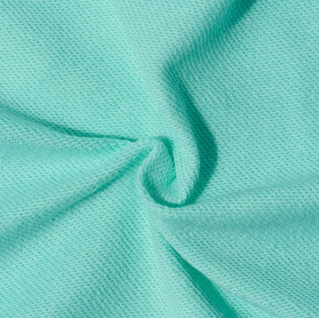 Close-up image of mint-green brushed cotton fabric with a soft, textured surface and slight folds.