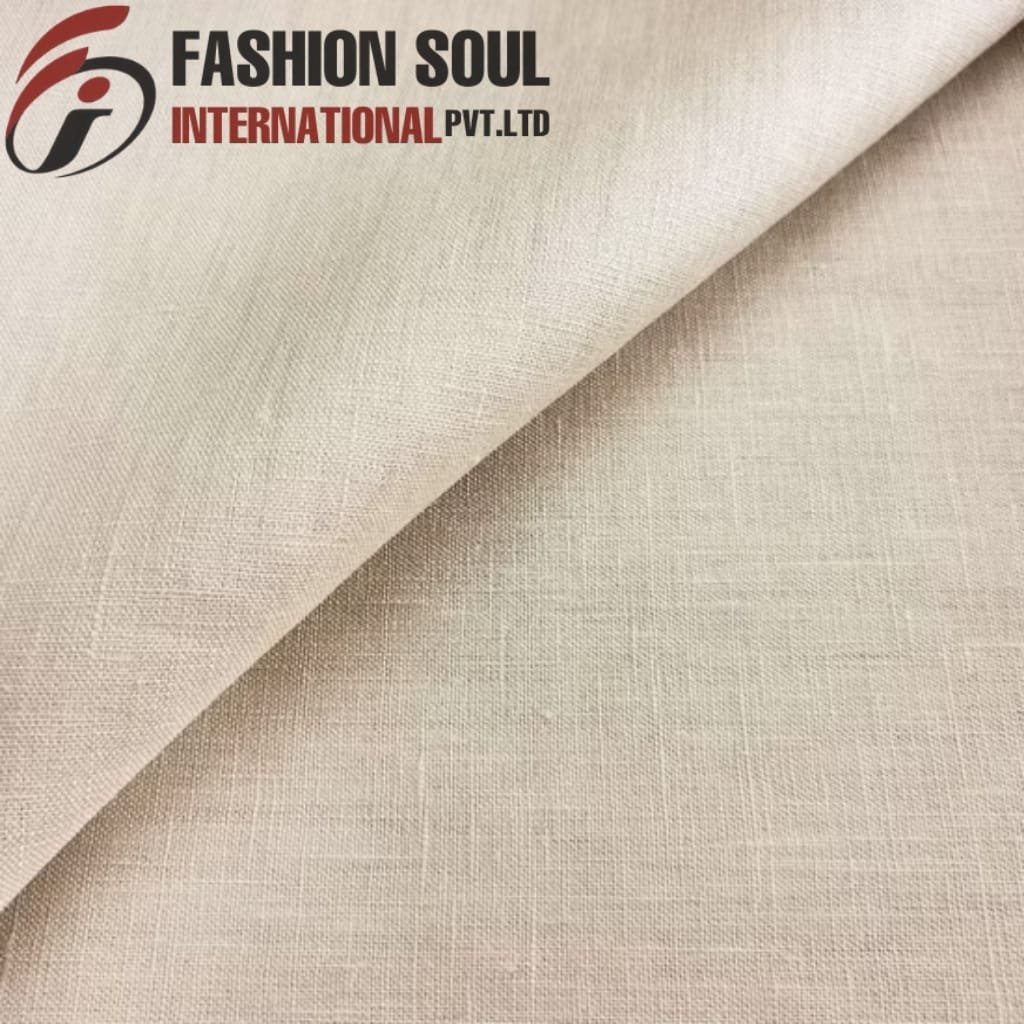  Close-up of cream-colored linen fabric with a subtle woven texture, folded diagonally.