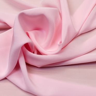 Close-up of crepe chiffon fabric with textured surface and flowing, gathered folds.